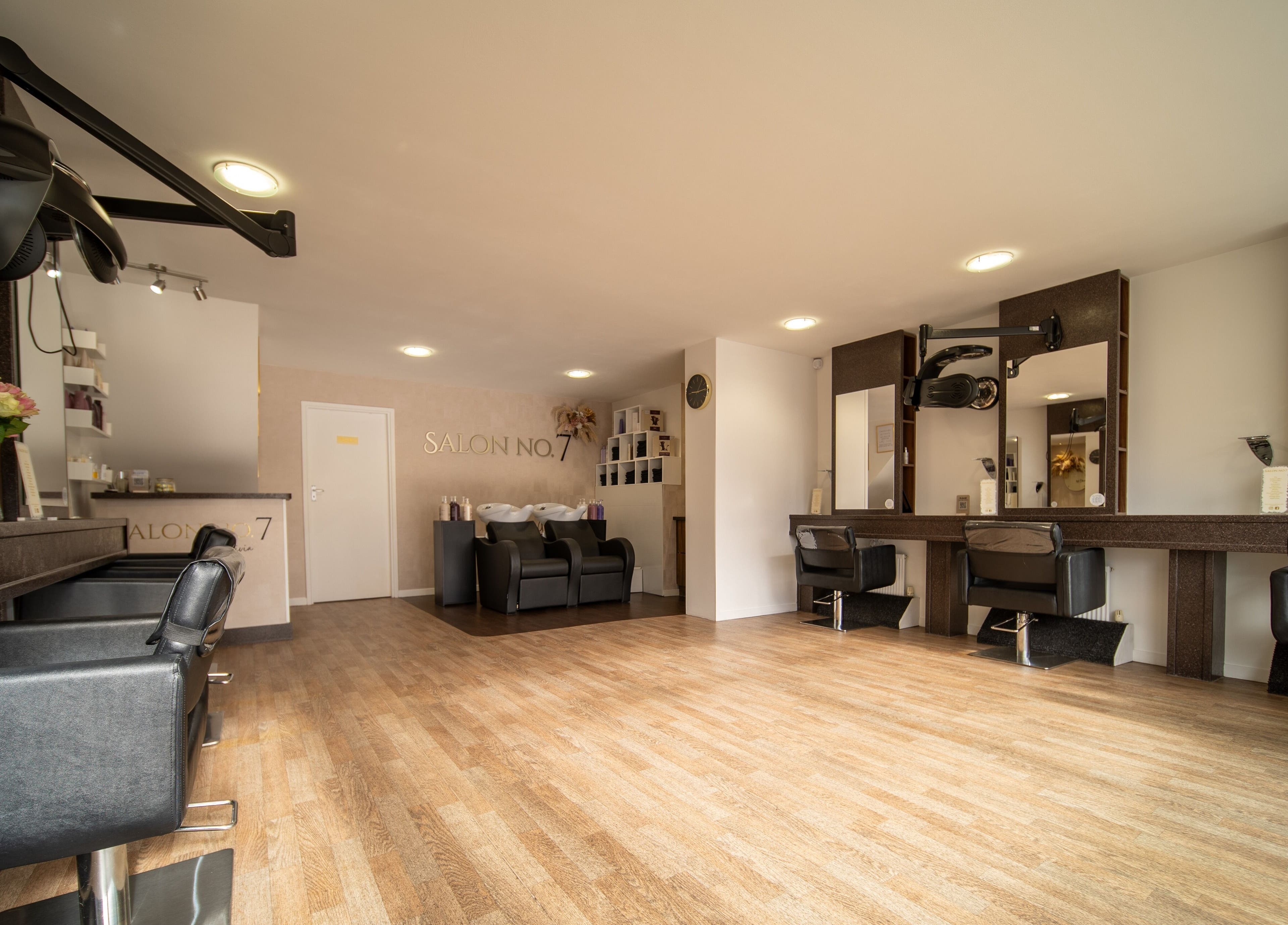 Elegant interior of Salon No.7 in Lytham St Annes, England, featuring modern chairs and mirrors.