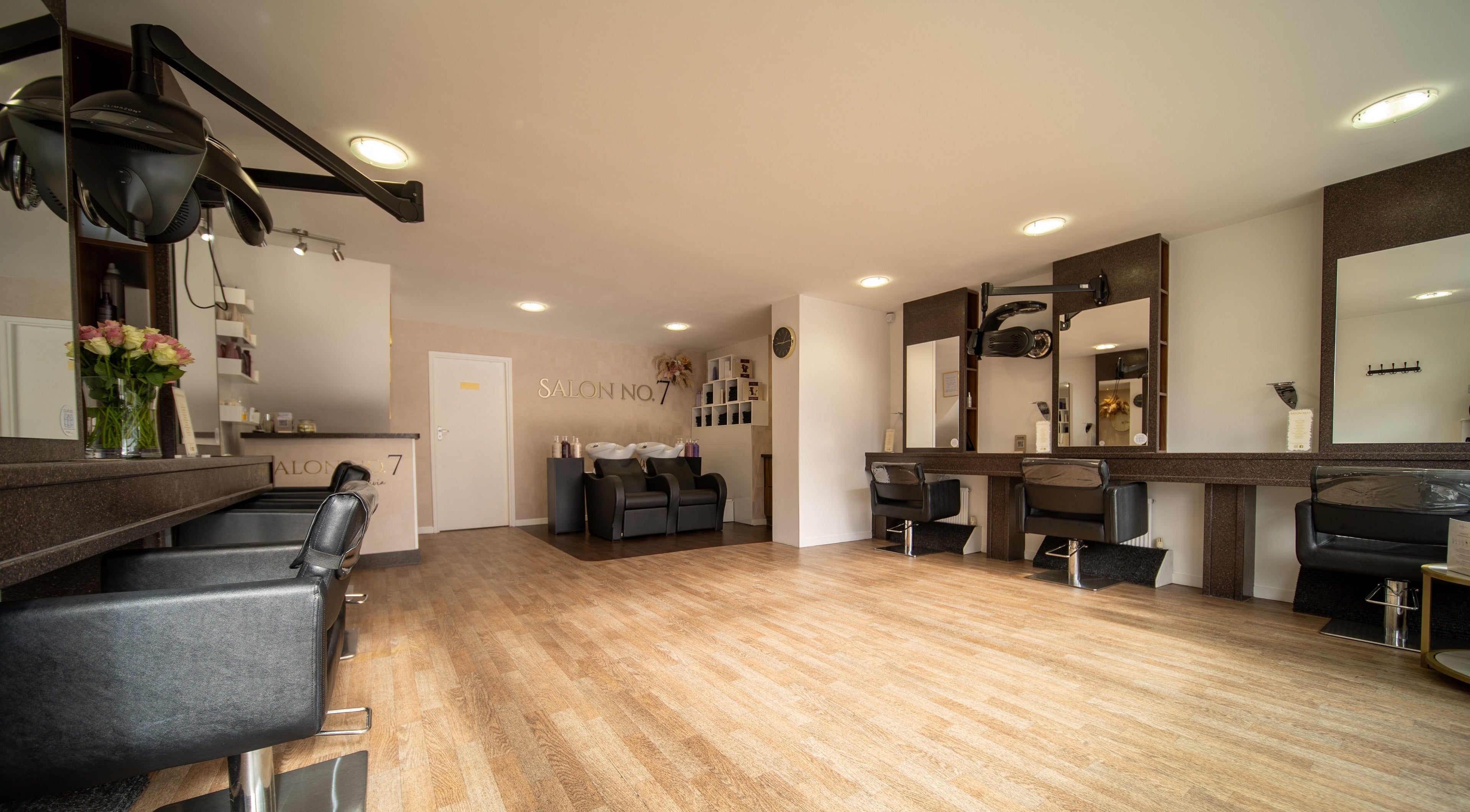 Elegant interior of Salon No.7 in Lytham St Annes, England, featuring modern chairs and mirrors.