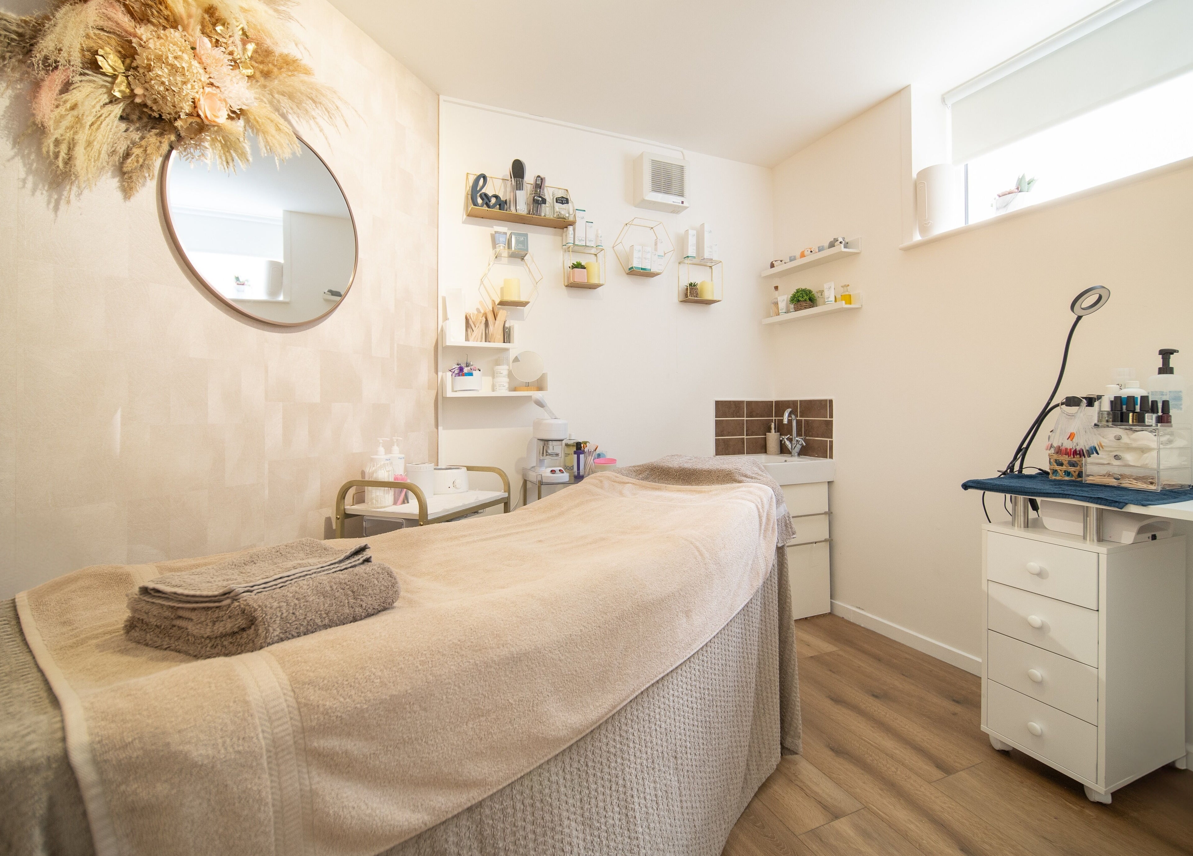 Well-lit treatment room at Salon No.7, Lytham St Annes, England, GB, with massage table and calming decor.