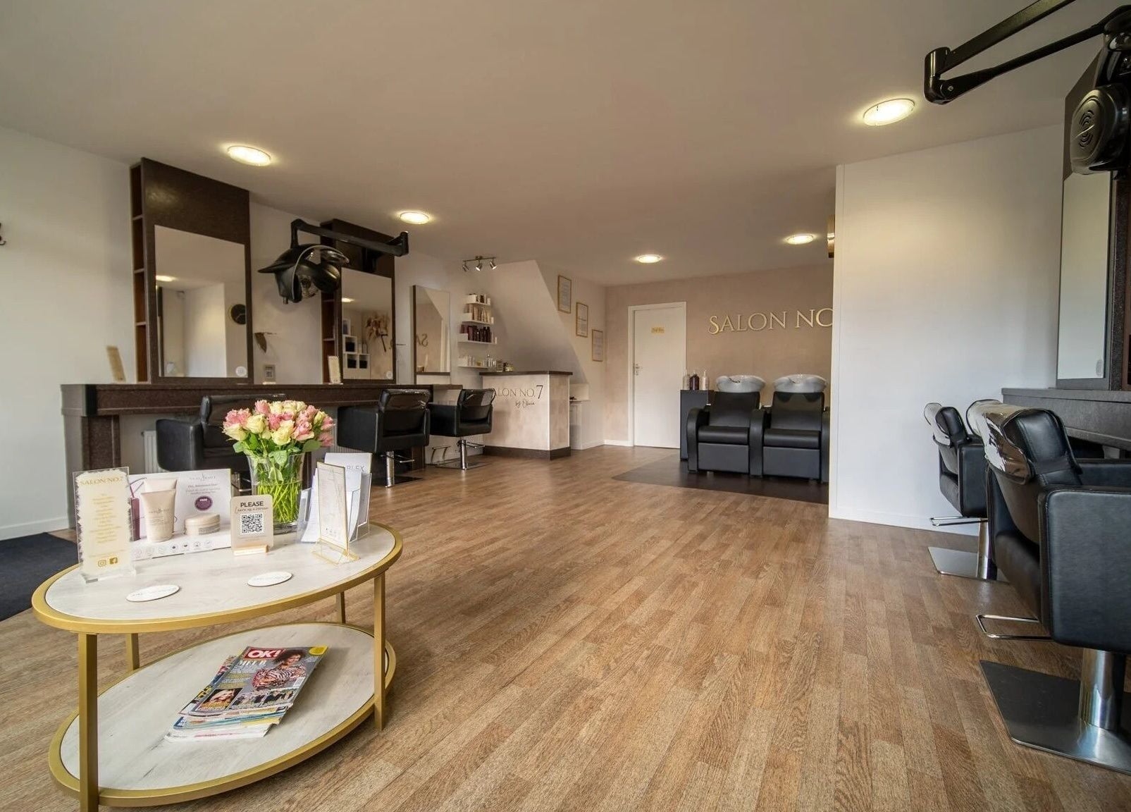 Modern interior of Salon No.7 in Lytham St Annes, England, GB with sleek styling stations and cozy seating.