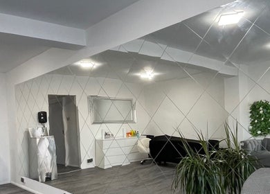 Modern interior of Eyelash Extensions Swansea with mirror wall, plants, and seating in Swansea, Wales, GB.