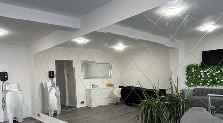 Modern interior of Eyelash Extensions Swansea with mirror wall, plants, and seating in Swansea, Wales, GB.