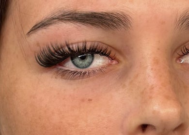 Detailed close-up of expertly applied eyelash extensions at Enhance by Han, Christchurch, GB.