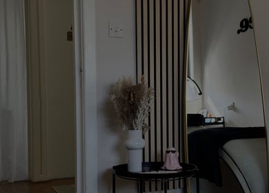 Stylish decor with mirror at Enhance Studios, Christchurch, GB reflecting elegance in the beauty space.