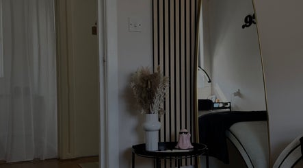 Stylish decor with mirror at Enhance Studios, Christchurch, GB reflecting elegance in the beauty space.