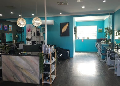 Chic interior of Highfields Hair in Highfields, Queensland, AU, featuring vibrant décor and styling stations.
