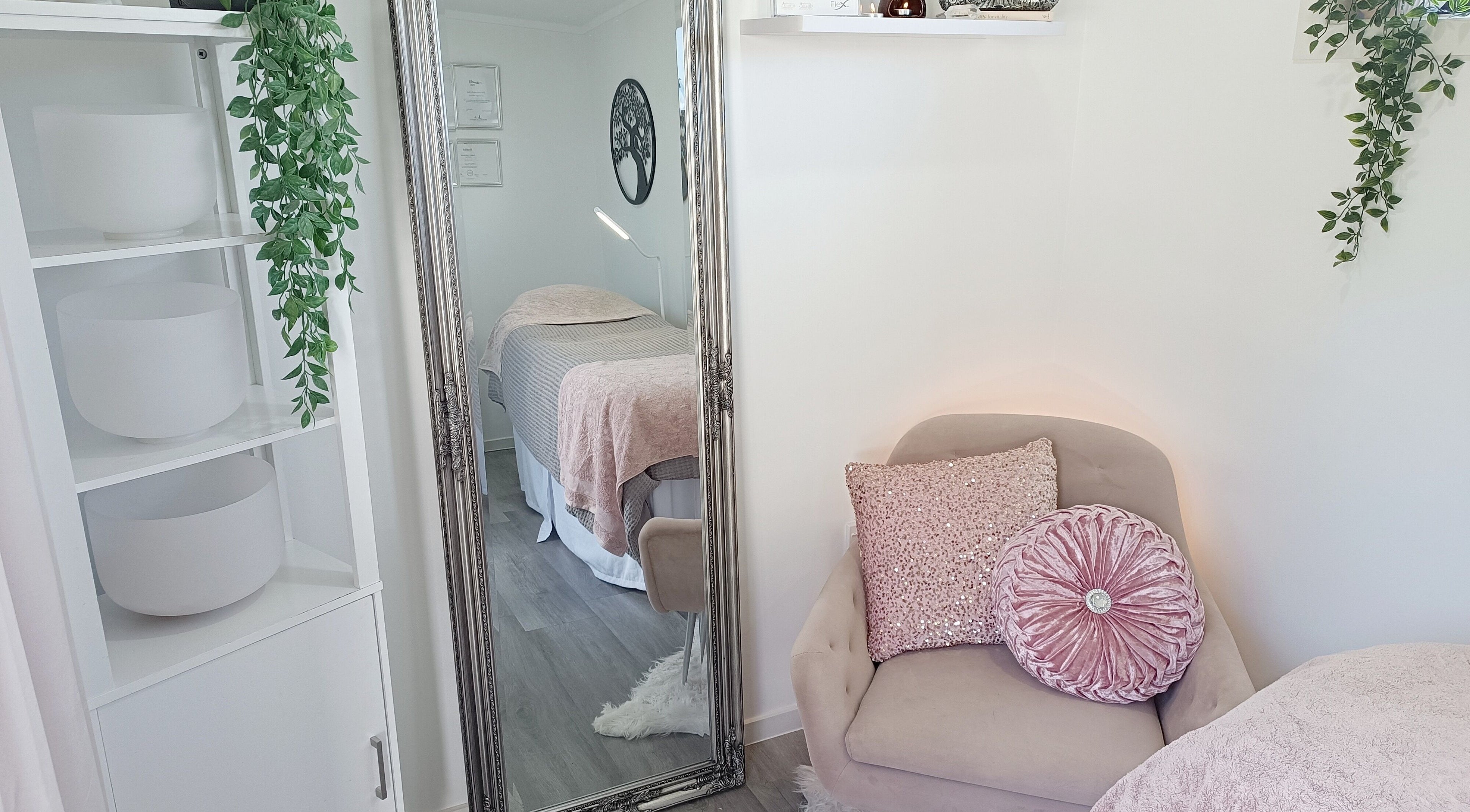Elegant beauty room at Platinum Beauty, Auckland, NZ, featuring plush seating and a serene massage table.