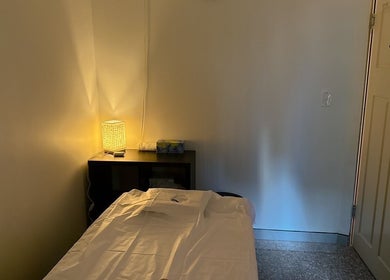 Cozy therapy room at Japanese Aromatherapy in Haymarket, New South Wales, AU with warm lighting and a massage bed.