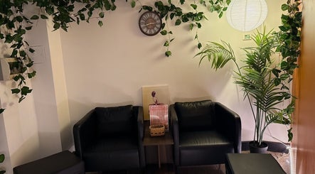 Cozy lounge at Japanese Aromatherapy in Haymarket, New South Wales, AU featuring plants and armchairs.