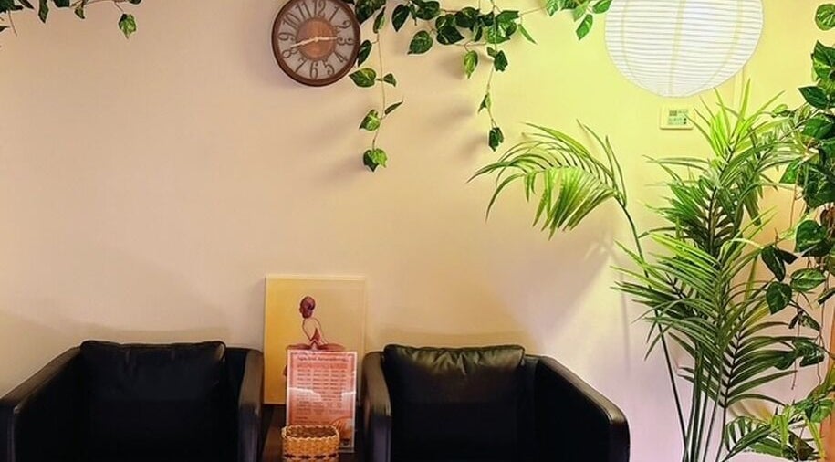 Relaxing seating area at Japanese Aromatherapy, Haymarket, New South Wales, AU, with plants and wall decor.