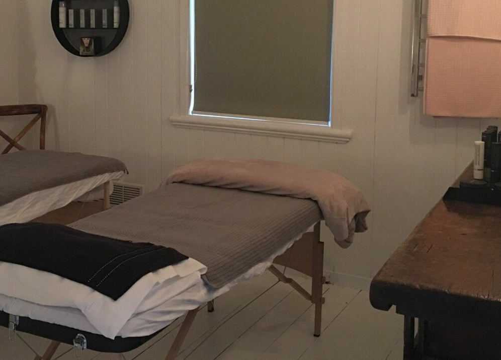 Cozy treatment room at Maleny Hair and Beauty, Maleny, Queensland, AU, with massage tables and products.