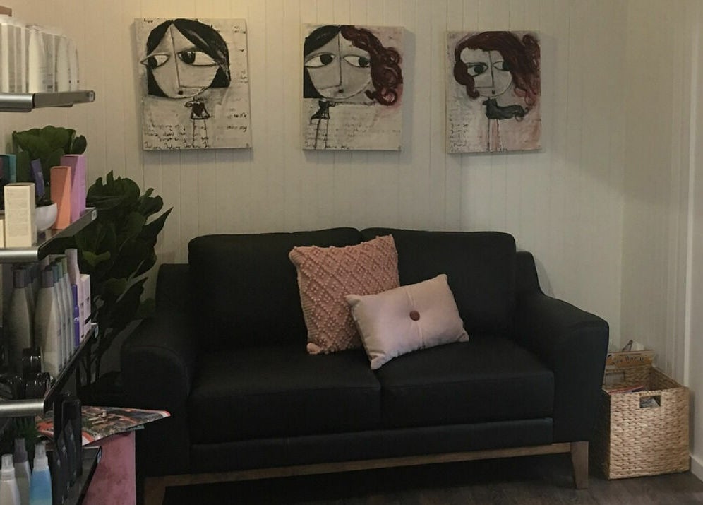 Modern lounge area in Maleny Hair and Beauty, Maleny, Queensland, AU with art and product display.