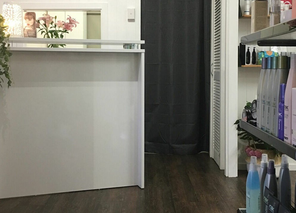 Reception area of Maleny Hair and Beauty in Maleny, Queensland, AU, featuring hair products and decor.