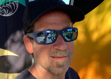 Brian @ Twelve Stone’s Salon in Fresno, California, US, with reflective sunglasses and abstract backdrop.