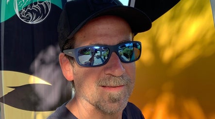 Brian @ Twelve Stone’s Salon in Fresno, California, US, with reflective sunglasses and abstract backdrop.