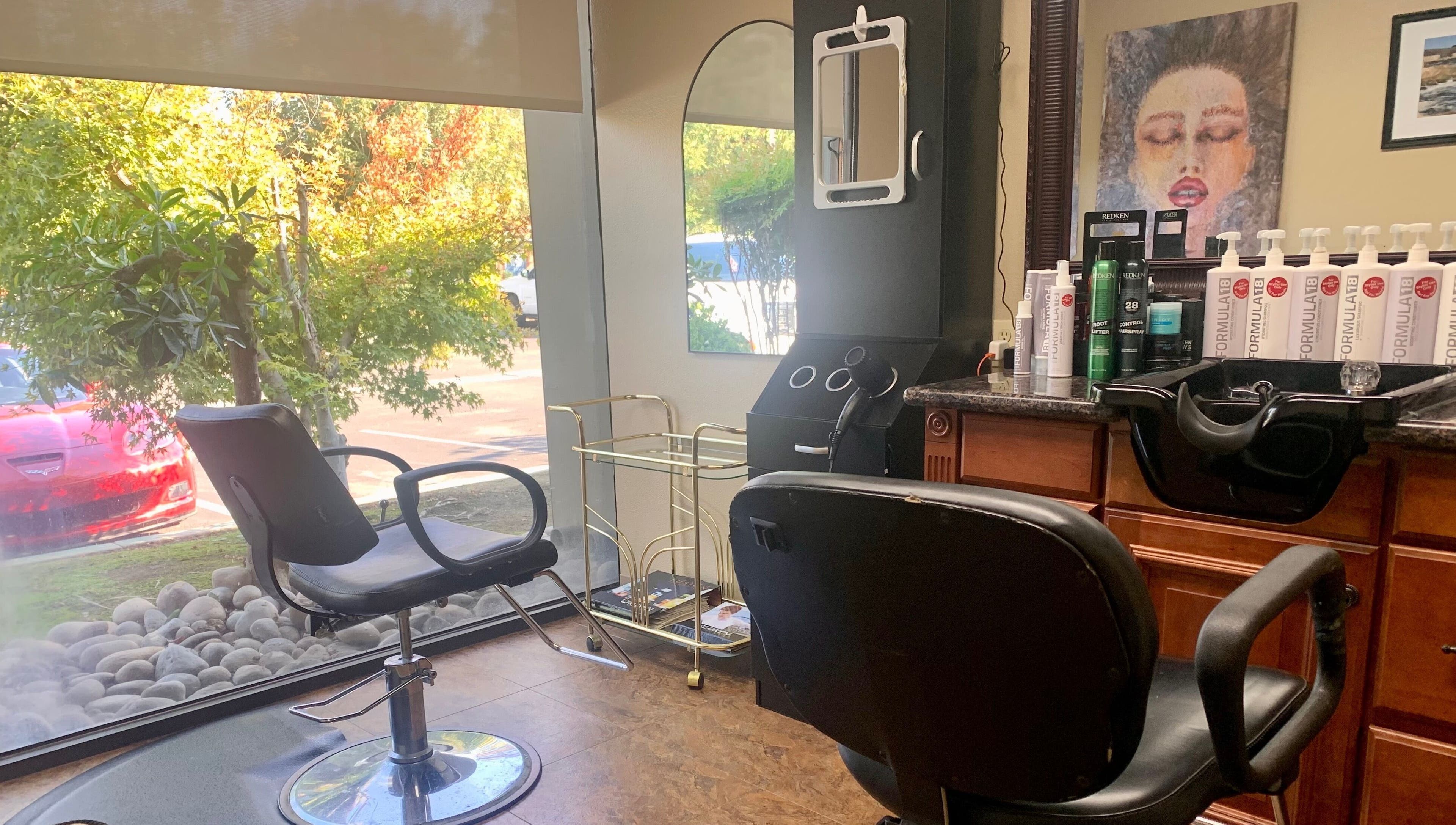 Interior view of Brian @ Twelve Stones Salon in Fresno, California, US, featuring stylish chairs and hair products.