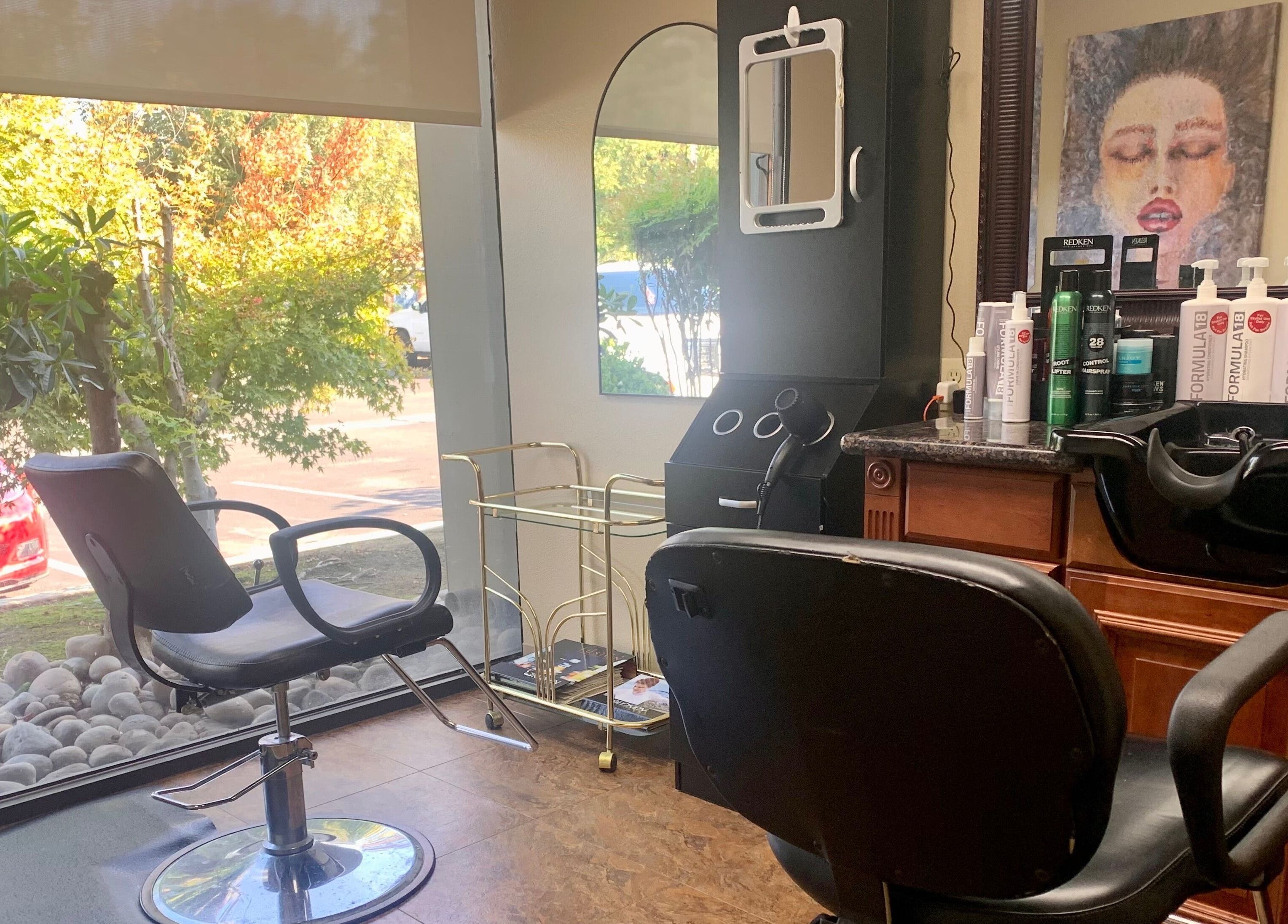 Interior view of Brian @ Twelve Stones Salon in Fresno, California, US, featuring stylish chairs and hair products.