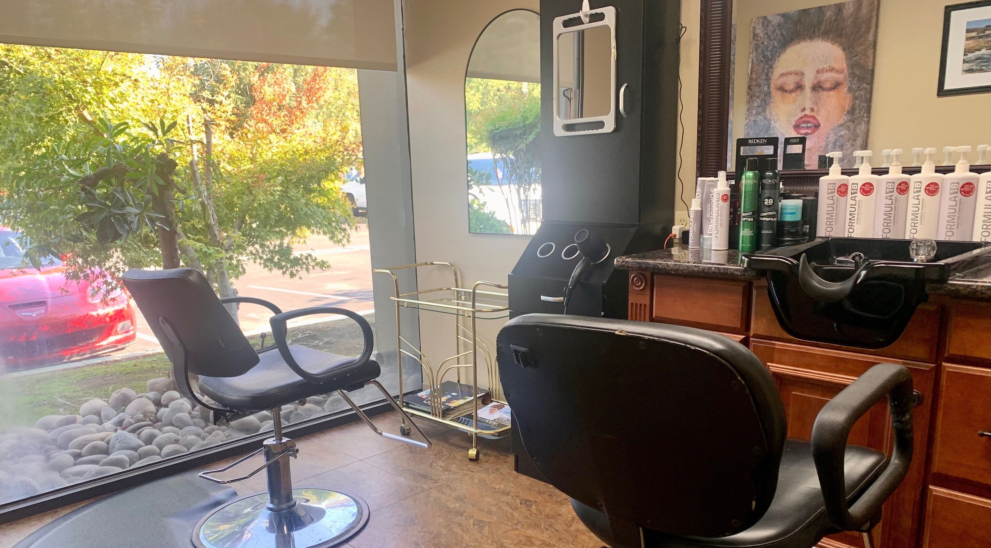 Interior view of Brian @ Twelve Stones Salon in Fresno, California, US, featuring stylish chairs and hair products.