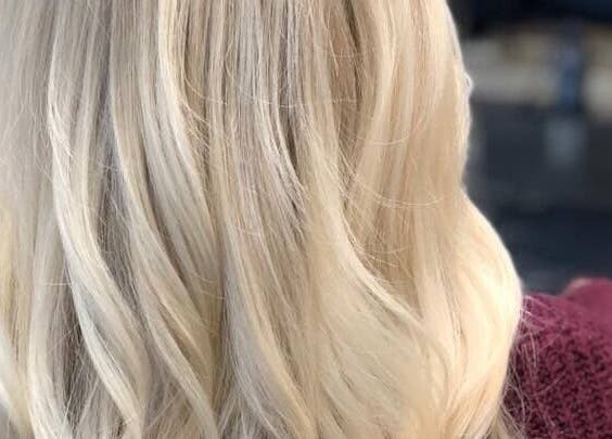 Blonde hair styled at Brian @ Twelve Stones Salon, Fresno, California, US, showcasing expert color and curl.