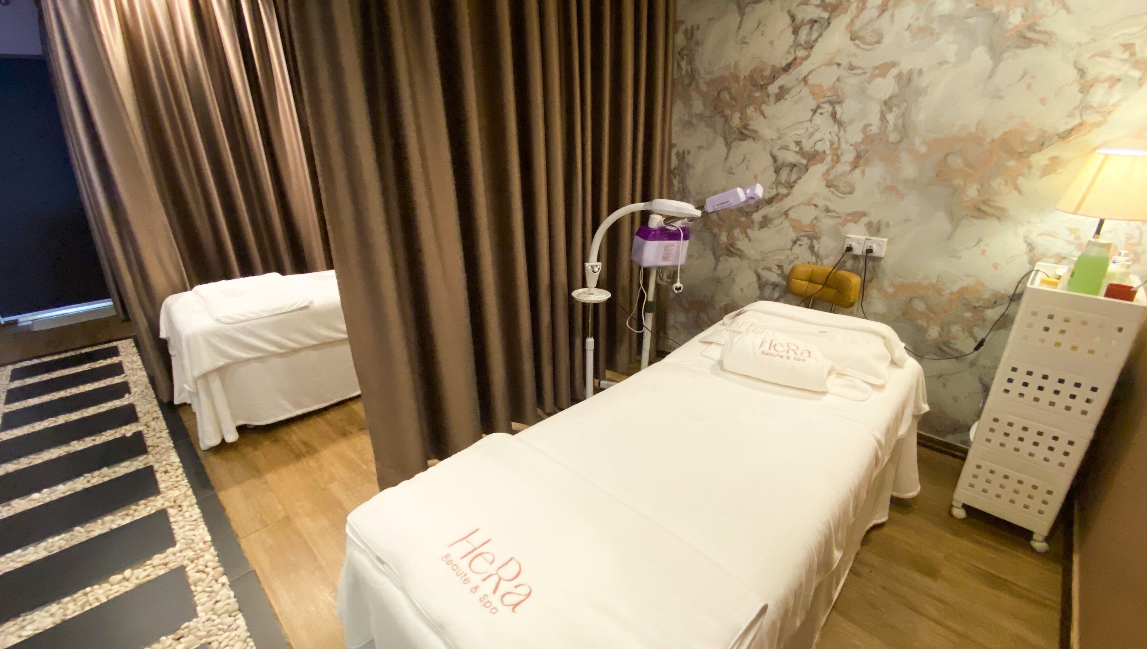 Tranquil spa room at Hera Beaute Spa in Nilai, Negeri Sembilan, MY with massage beds and soft lighting.
