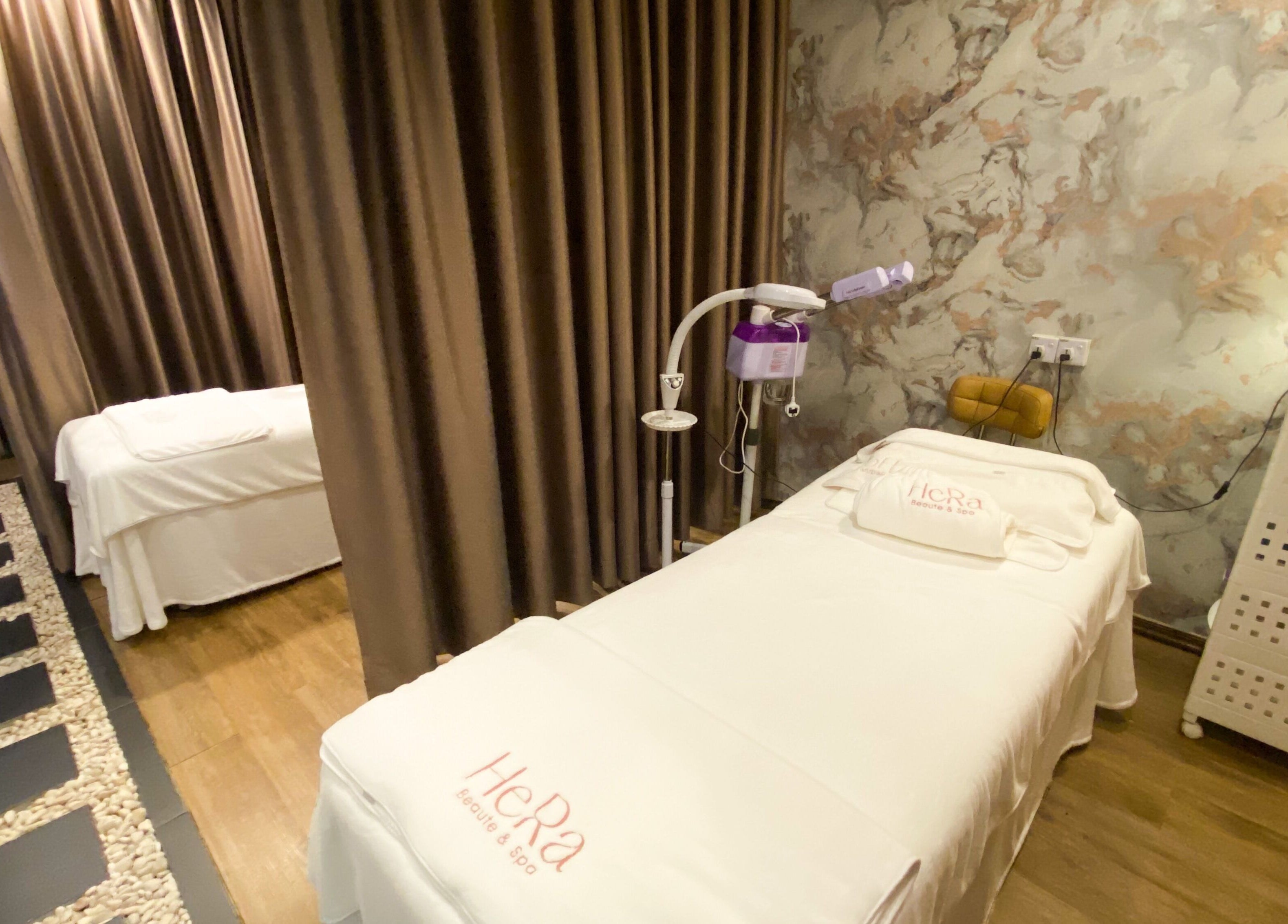 Tranquil spa room at Hera Beaute Spa in Nilai, Negeri Sembilan, MY with massage beds and soft lighting.