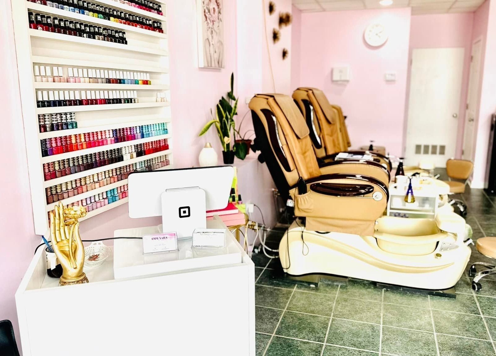 Modern interior of GMM Nails in Highland Park, Illinois, US featuring nail polish display and pedicure stations.