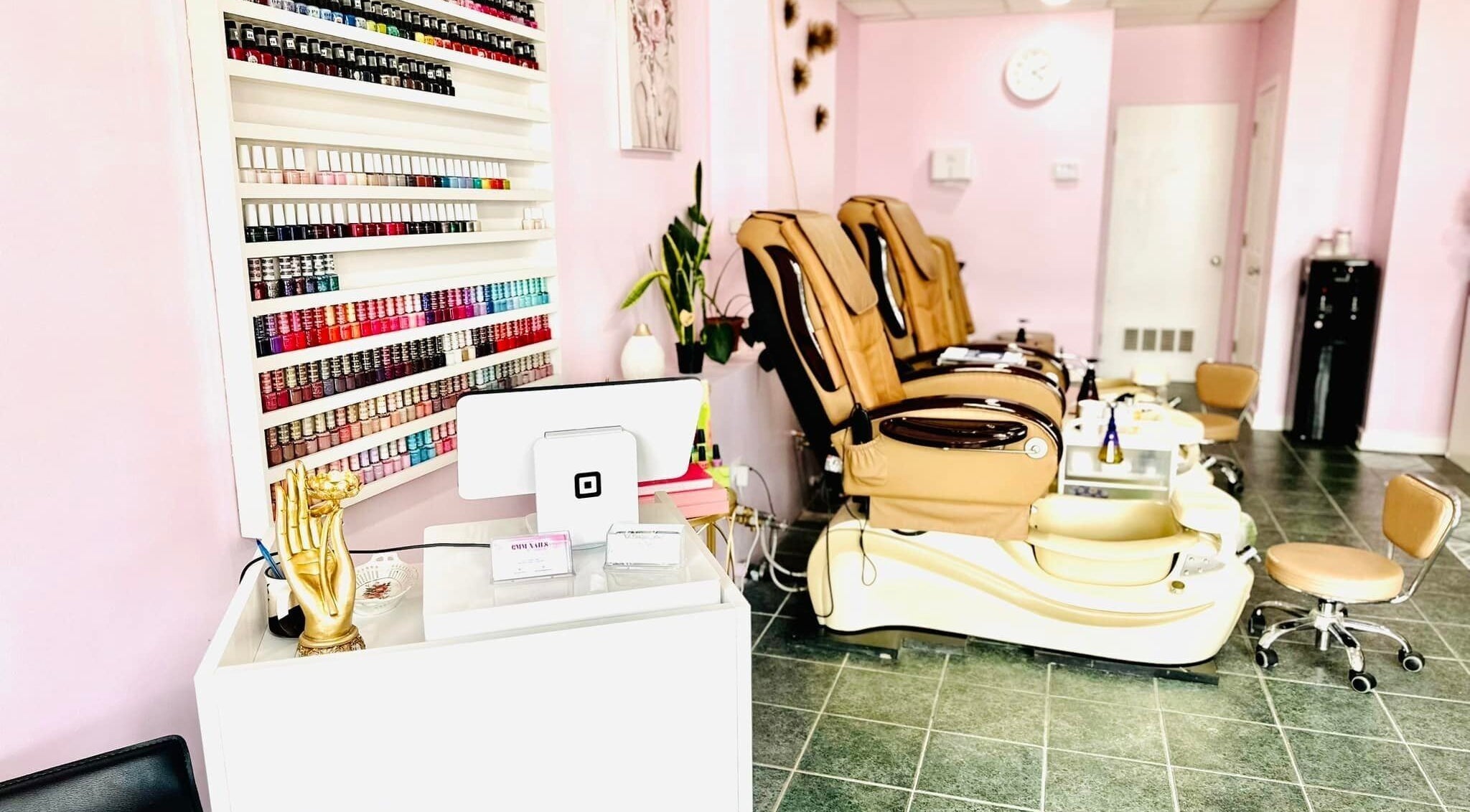 Modern interior of GMM Nails in Highland Park, Illinois, US featuring nail polish display and pedicure stations.