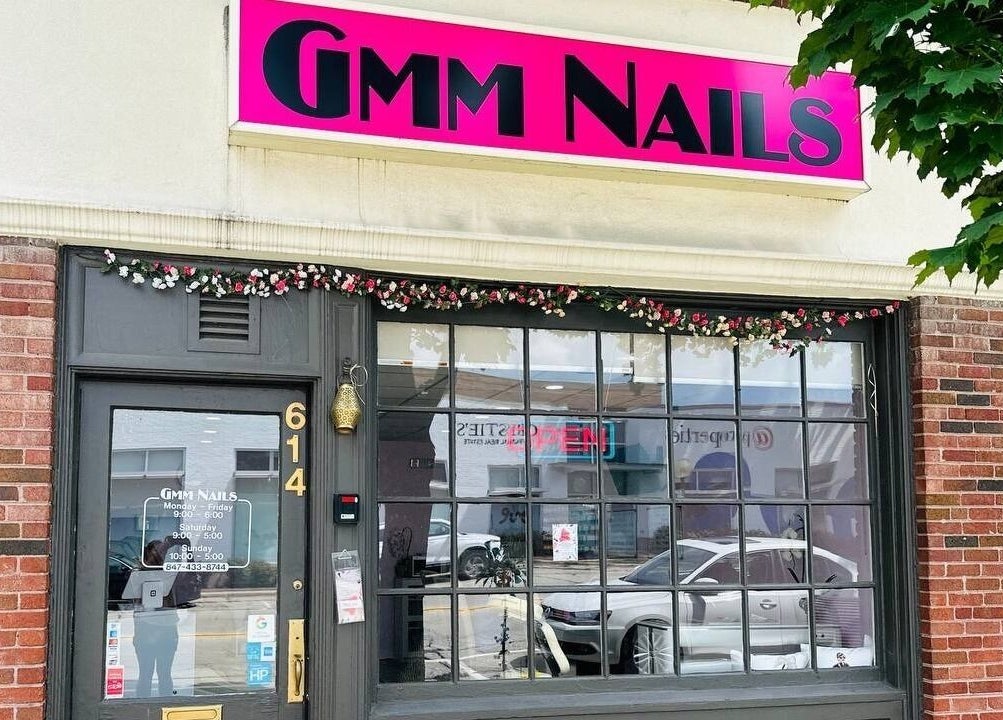 Exterior of GMM Nails in Highland Park, Illinois, featuring brick facade and vibrant signage.
