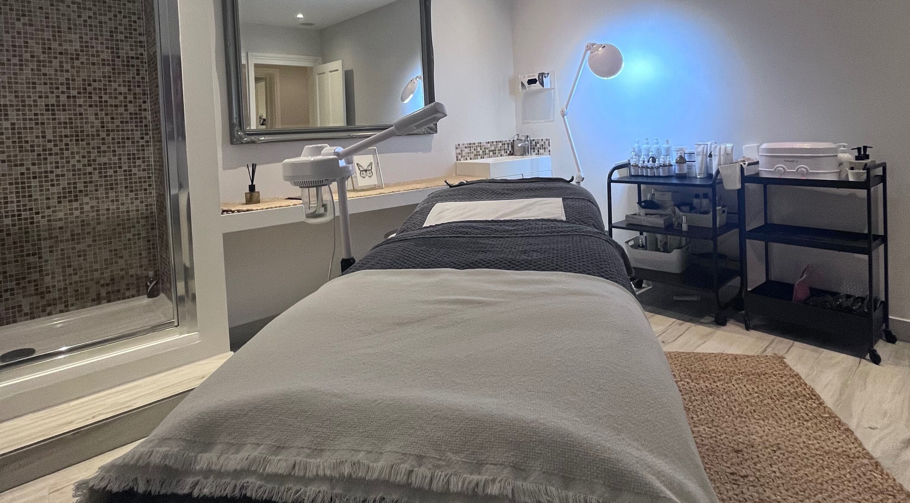 Tranquil treatment room at Village Aesthetics and Beauty in London, England, GB, featuring a cozy spa bed.