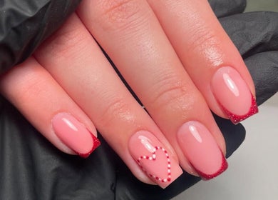 Stylish pink manicure with heart design at Glow Beauty by Karagh, Carlisle, England, GB.