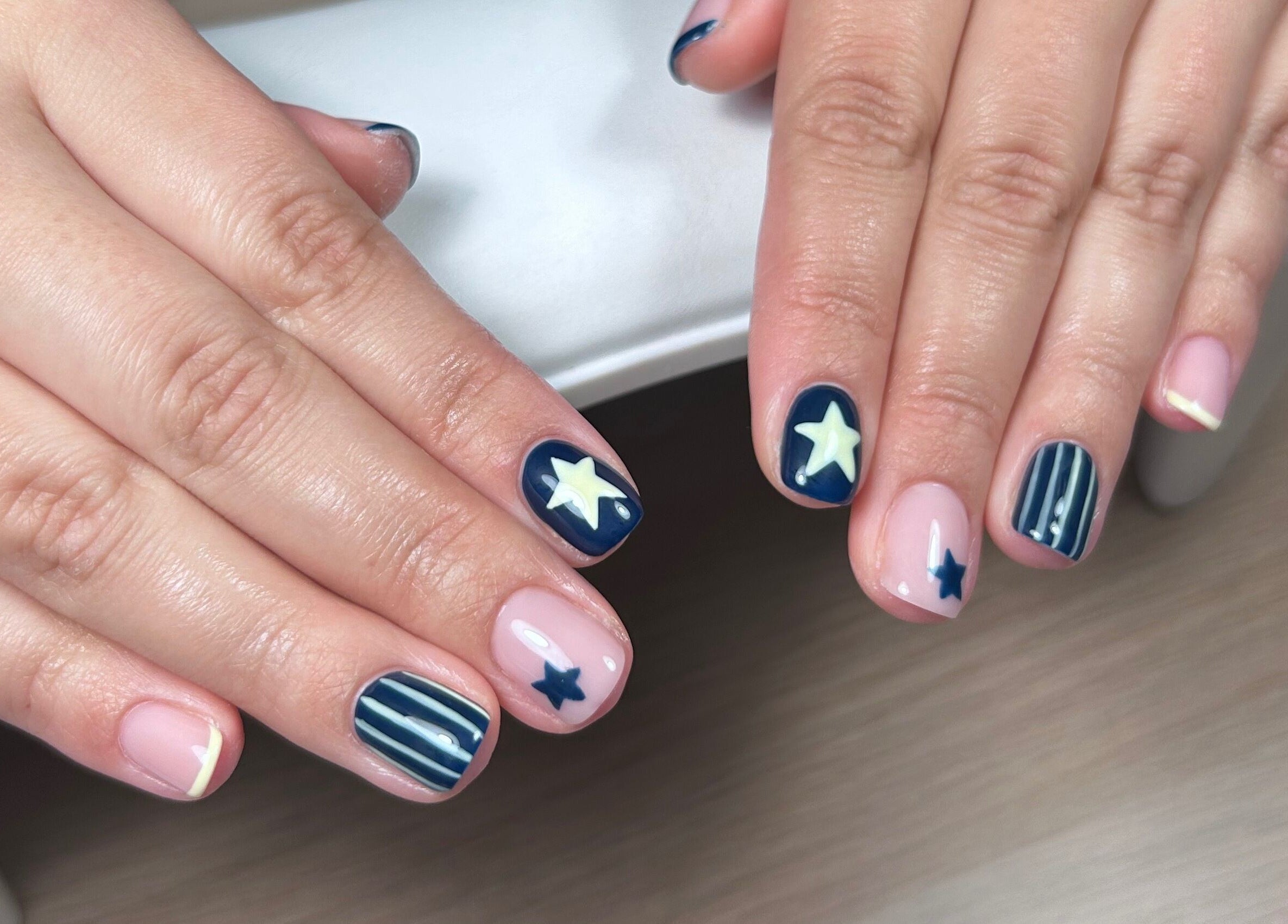 Starry manicure at MANI Studio in Victoria, Victoria, AU showcasing blue and white nail art.