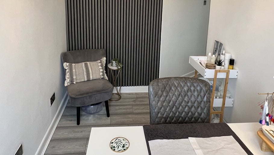 Elegant treatment room at HD Skin Clinic Lancs in Euxton, England, GB, featuring a stylish chair and products.