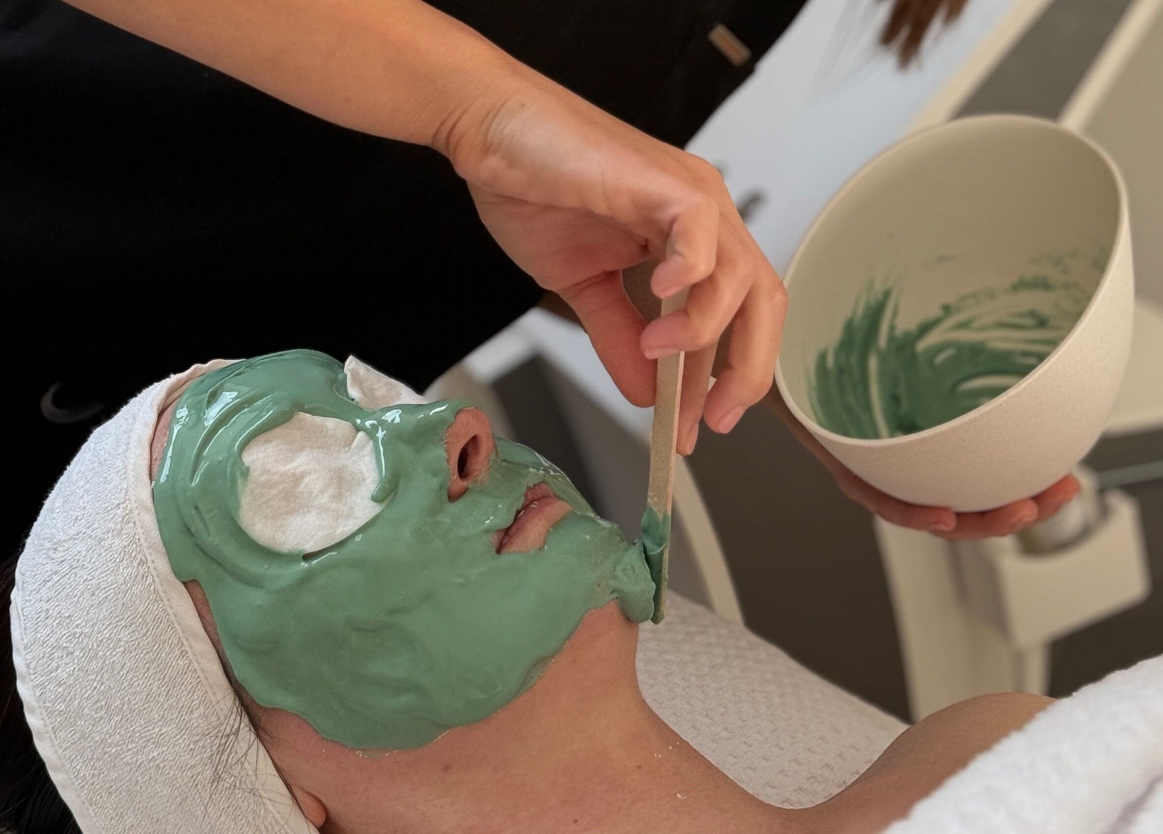 Relaxing facial treatment at HD Skin Clinic Lancs in Euxton, England, GB with a soothing green face mask.