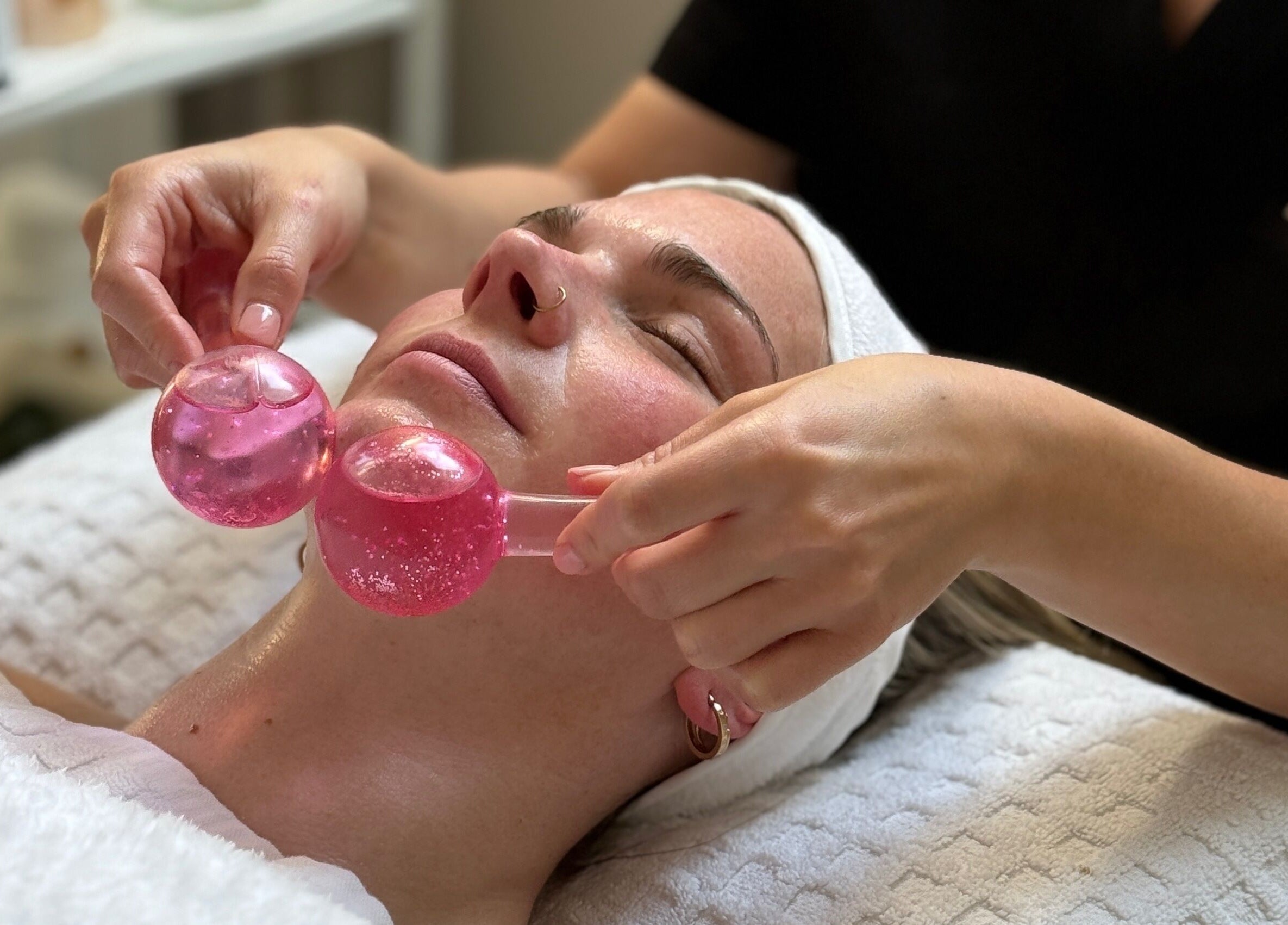 Facial massage with pink globes at HD Skin Clinic Lancs, Euxton, England, GB enhances relaxation.