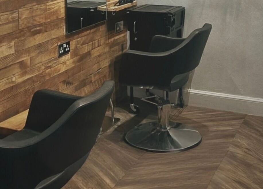 Stylish salon chairs at Emma James-Creative Salon, North Berwick, Scotland, GB with chic wooden decor.