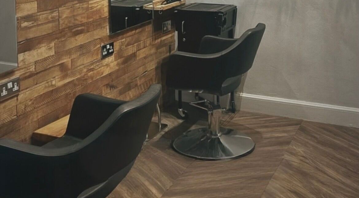 Stylish salon chairs at Emma James-Creative Salon, North Berwick, Scotland, GB with chic wooden decor.