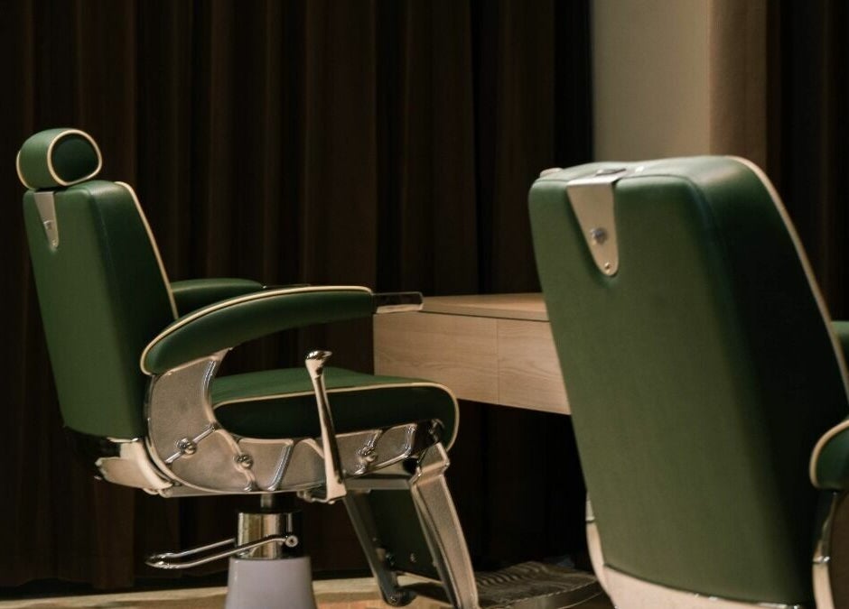 Elegant green barber chairs at Float Barbershop, Sharjah, Sharjah, AE, offering premium grooming services.
