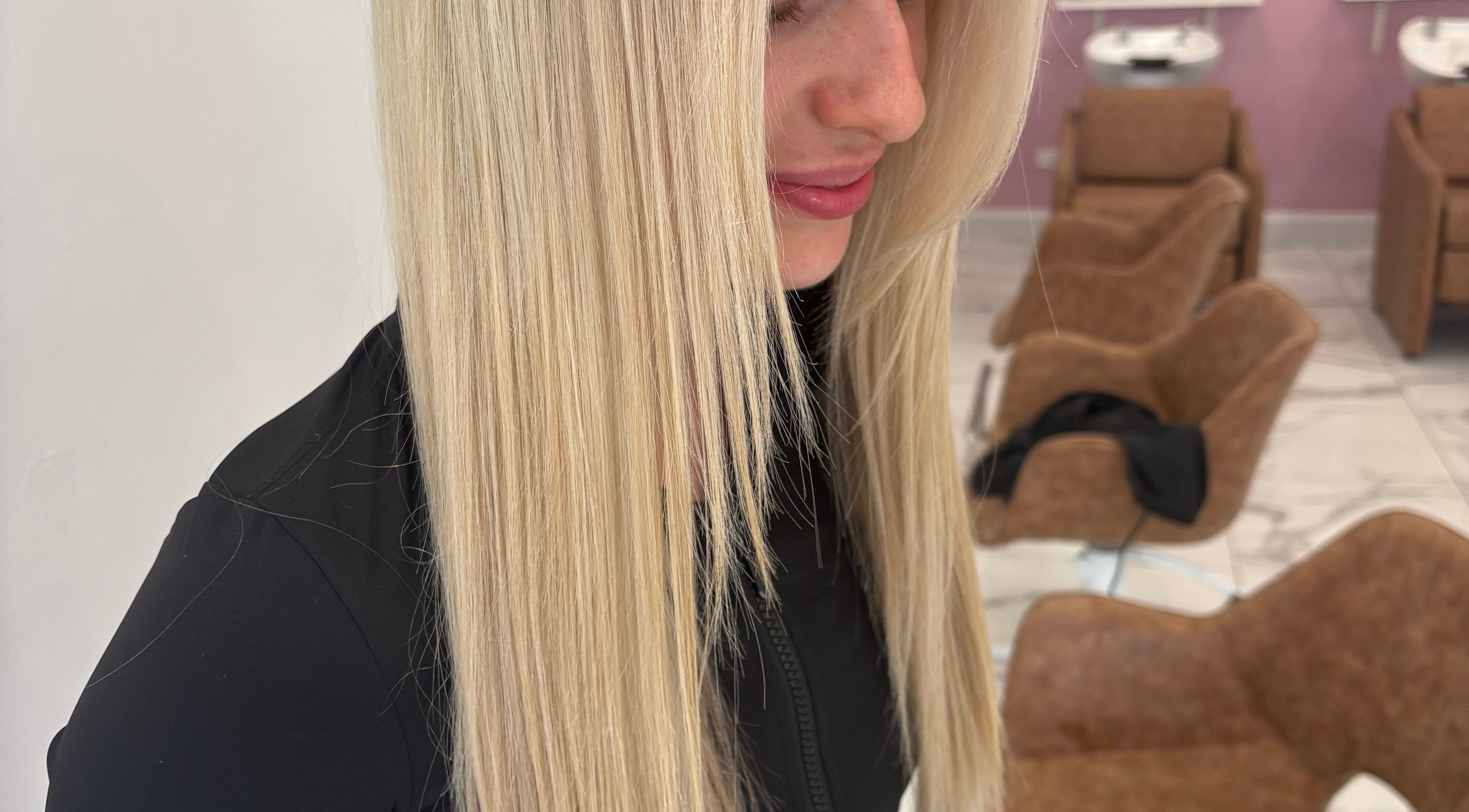 A woman with sleek blonde hair at Starr Hair Studio, Findon, South Australia, AU, showcasing modern styling.