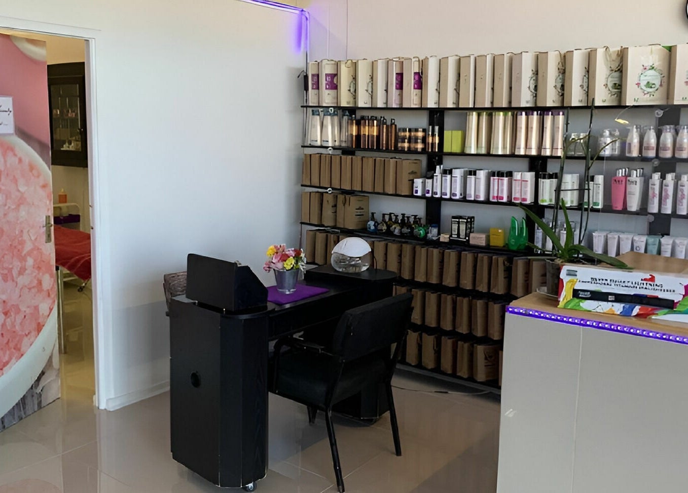 Inside Be-dazzle Strandfontein, Cape Town, Western Cape, ZA, showcasing beauty products and a cozy seating area.