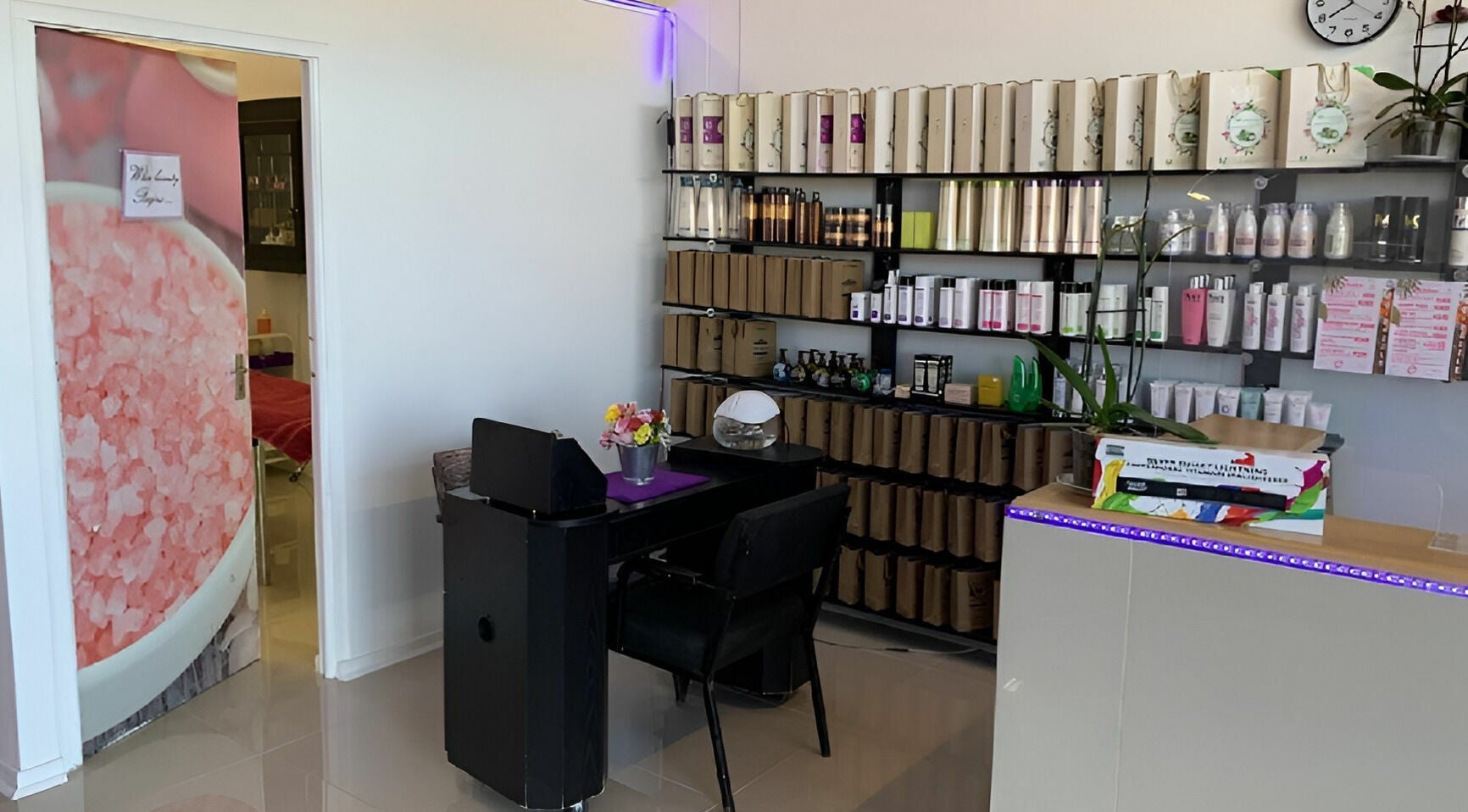 Inside Be-dazzle Strandfontein, Cape Town, Western Cape, ZA, showcasing beauty products and a cozy seating area.