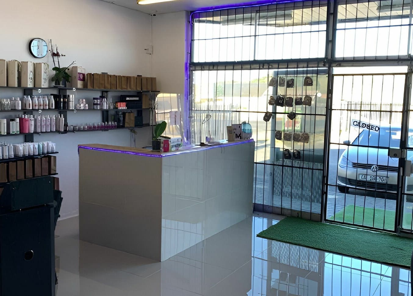 Be-dazzle Strandfontein reception area with sleek design and product shelves, Cape Town, Western Cape, ZA.