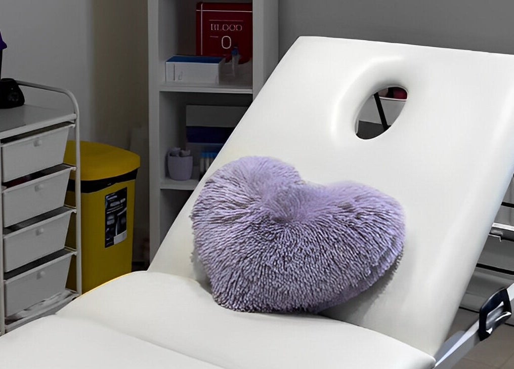 Relaxing treatment bed with a purple pillow at Maha Aesthetics Clinic in London, England, GB.