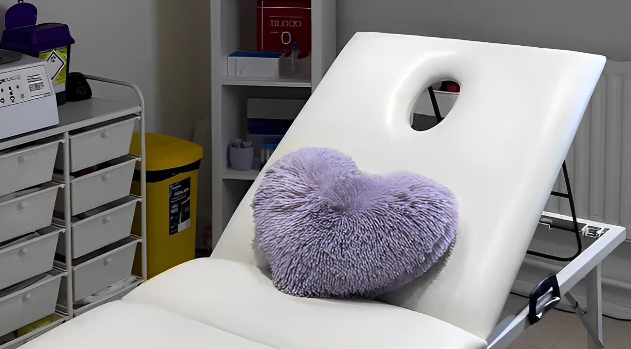 Relaxing treatment bed with a purple pillow at Maha Aesthetics Clinic in London, England, GB.