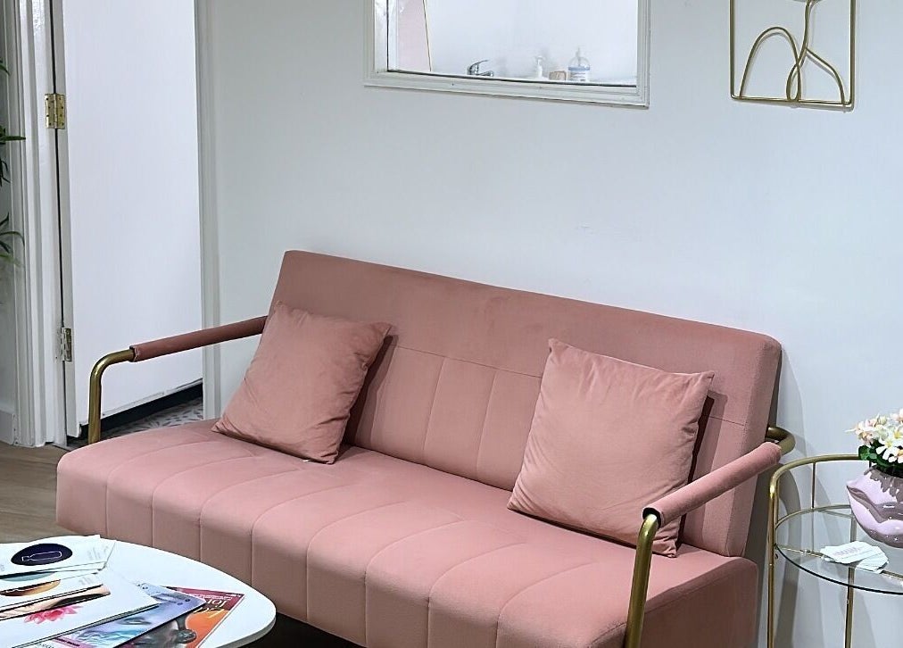 Cozy blush sofa in Maha Aesthetics Clinic, London, England, GB with chic decor.
