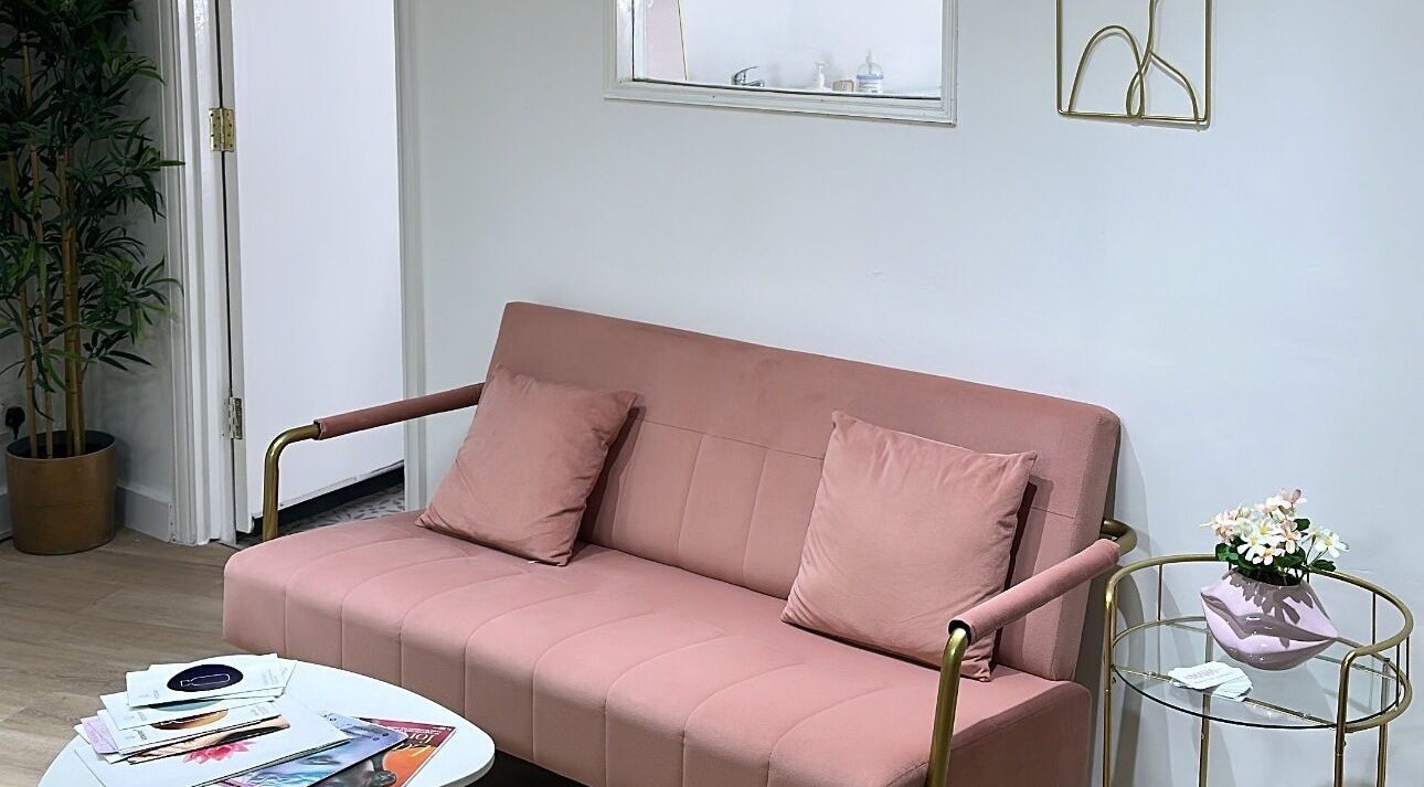 Cozy blush sofa in Maha Aesthetics Clinic, London, England, GB with chic decor.