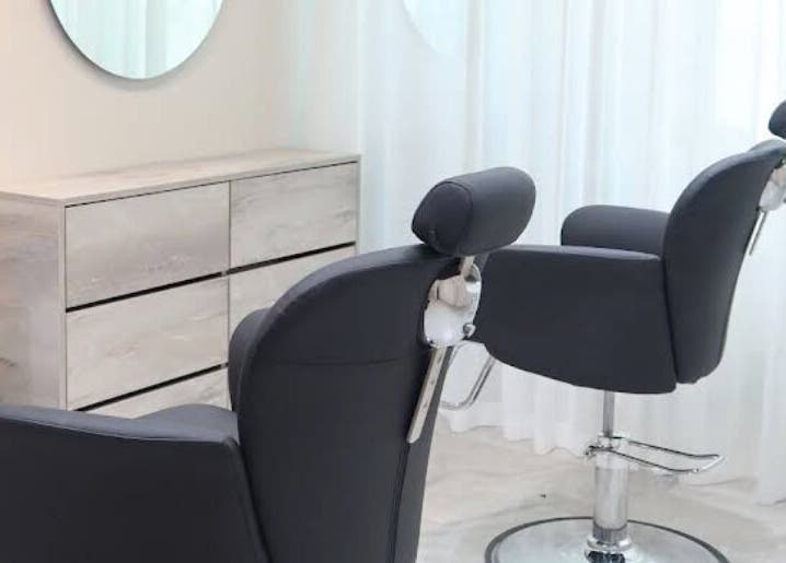 Modern salon chairs at Azizam - Lashes & Brows in Dubai, AE, offering a sleek, comfortable setting for beauty treatments.