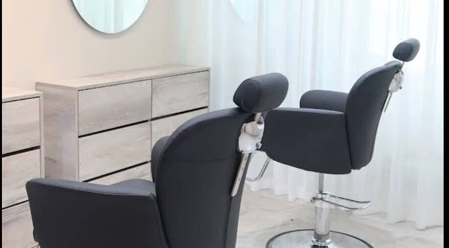 Modern salon chairs at Azizam - Lashes & Brows in Dubai, AE, offering a sleek, comfortable setting for beauty treatments.
