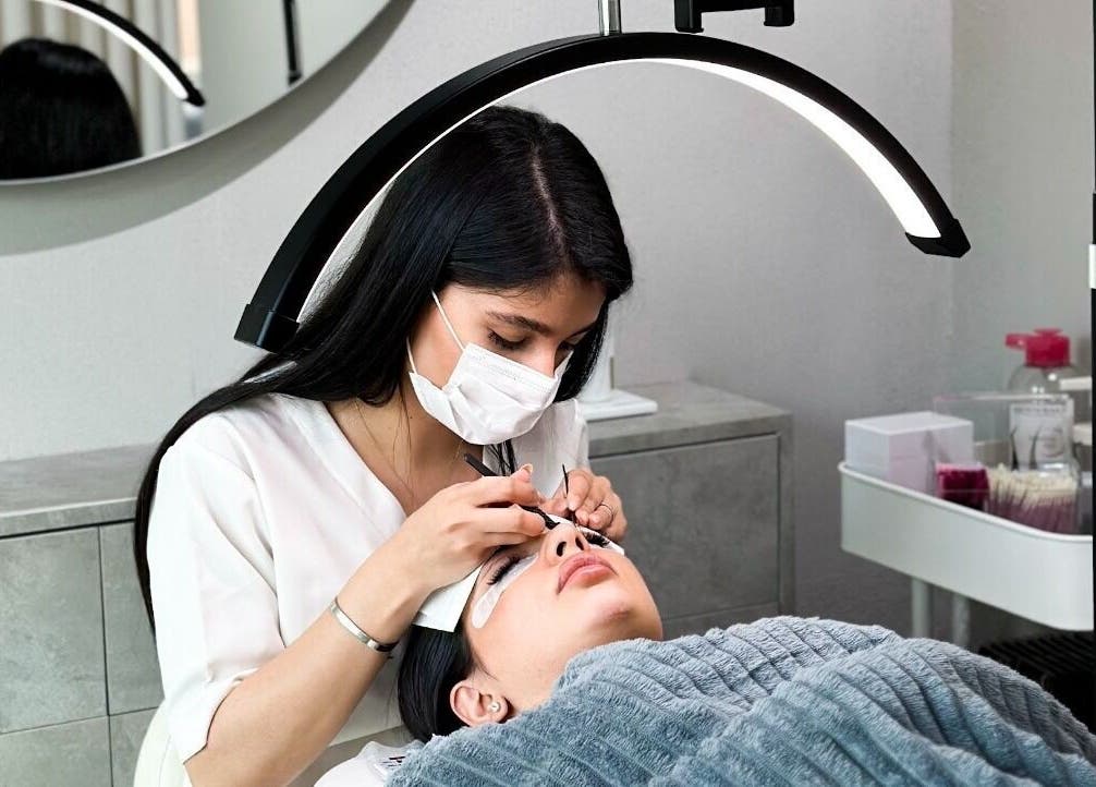 Technician applies eyelash extensions at Azizam - Lashes & Brows, Dubai, AE.