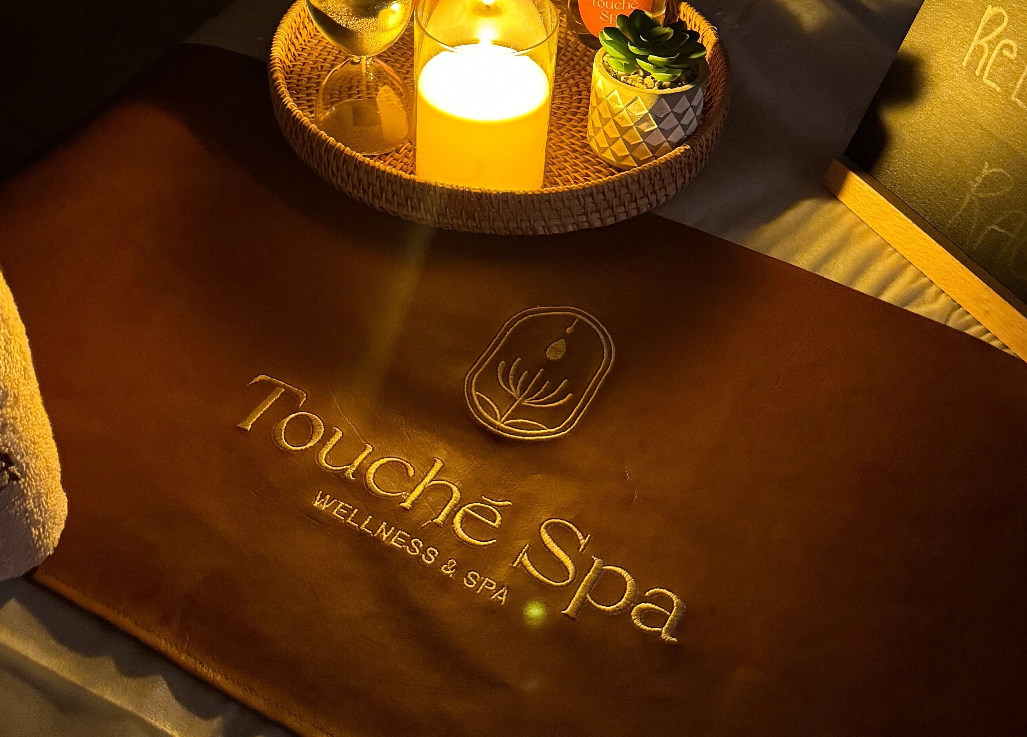 Touché Spa | Home Service ambiance with candle and towel in Jeddah, Makkah Province, SA.