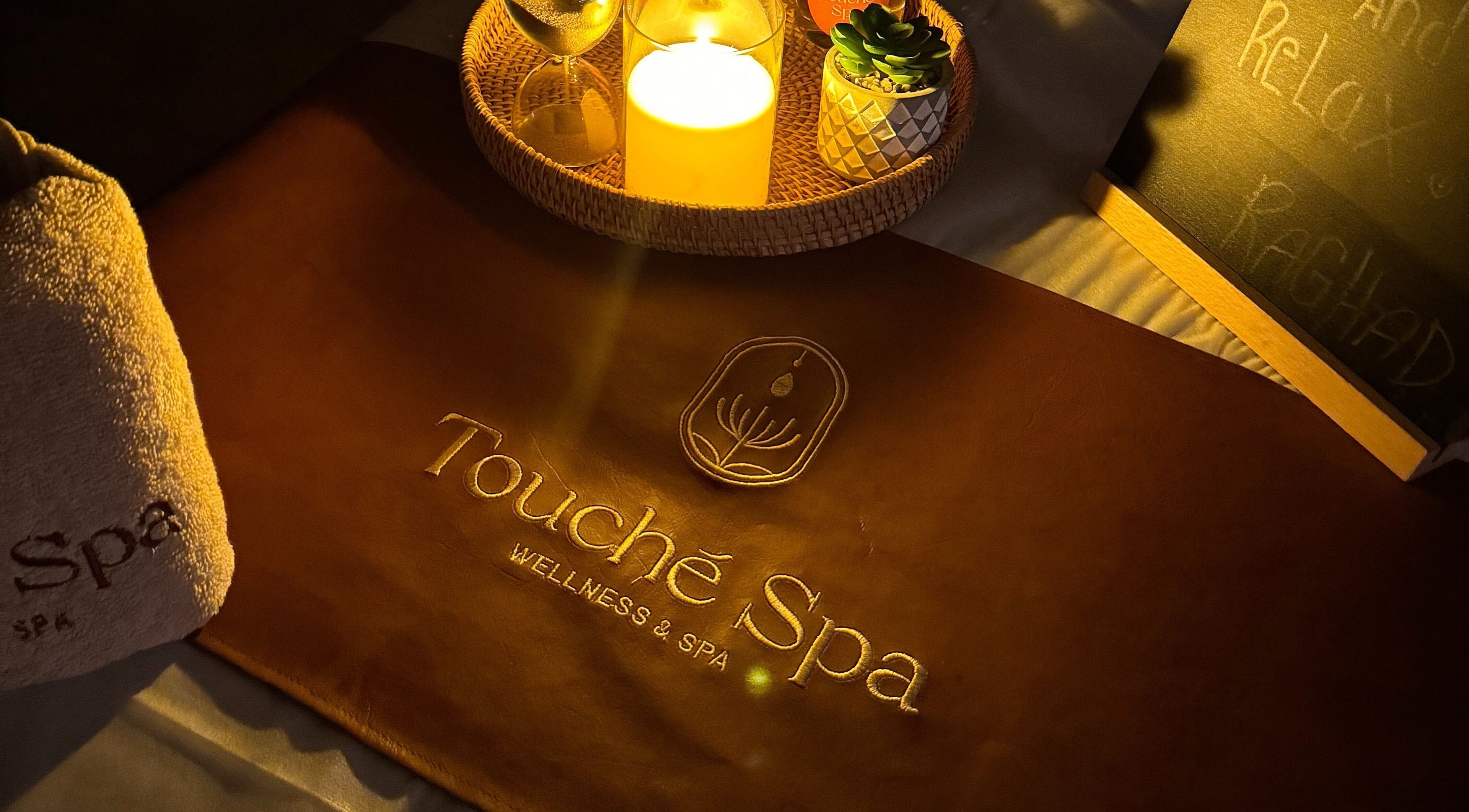 Touché Spa | Home Service ambiance with candle and towel in Jeddah, Makkah Province, SA.